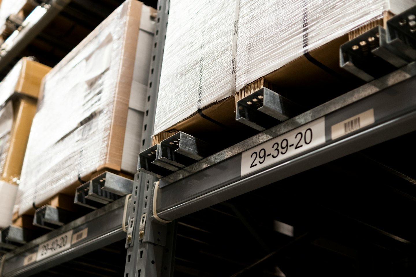 Inventory stacked on metal shelves in a warehouse.